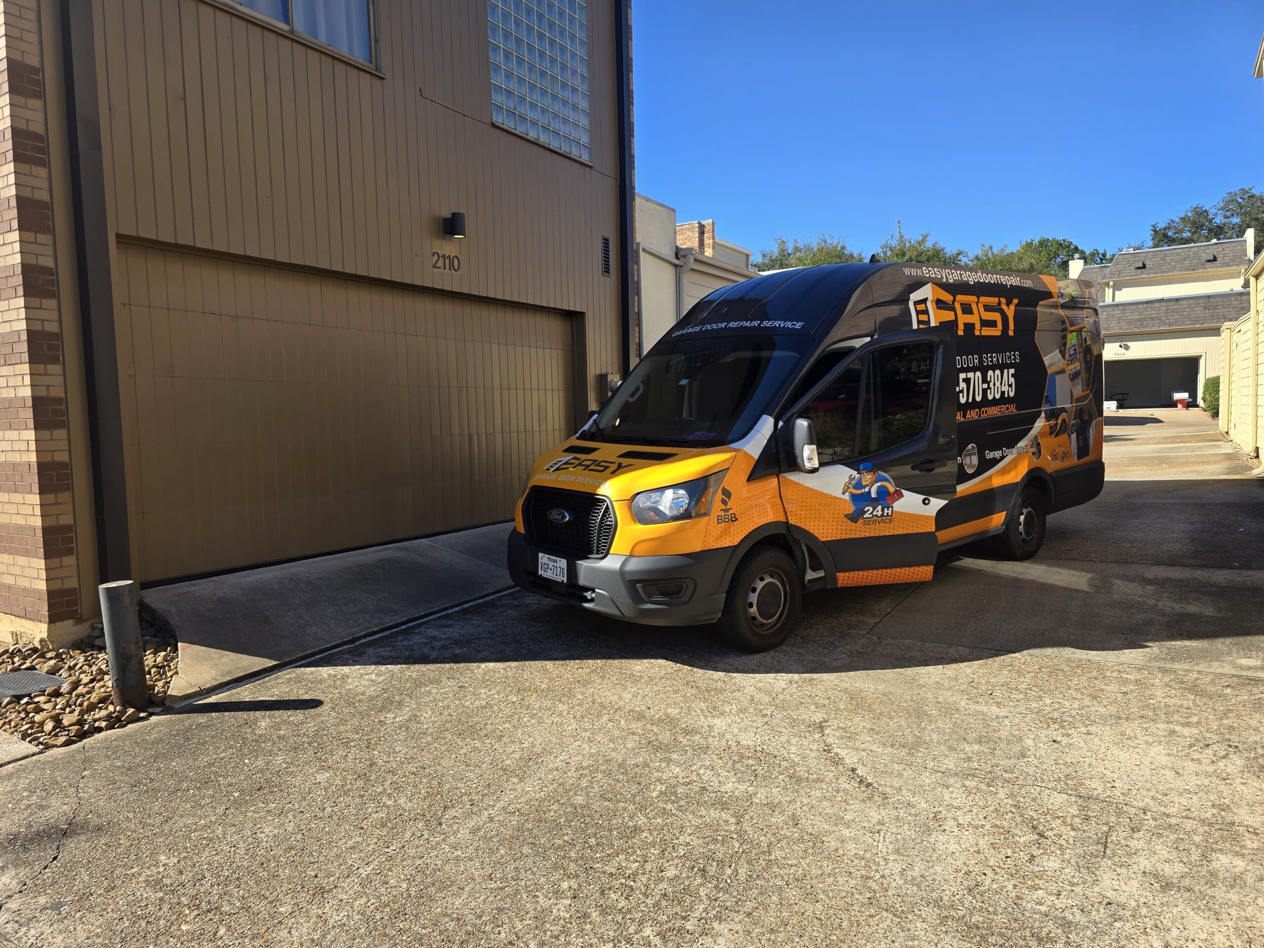 Heavy wooden carriage garage door repaired in Bellaire, TX