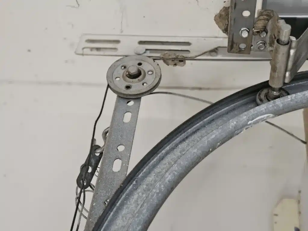 Houston garage door technician diagnosing a door that closes and opens again
