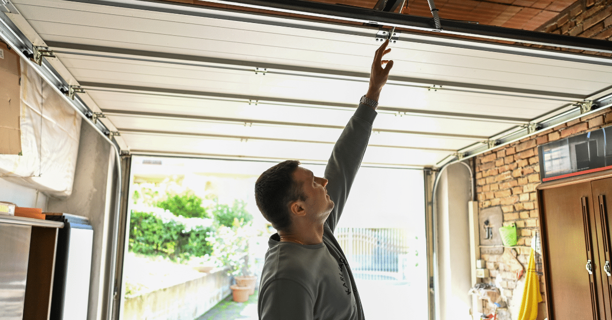 person checking garage door parts