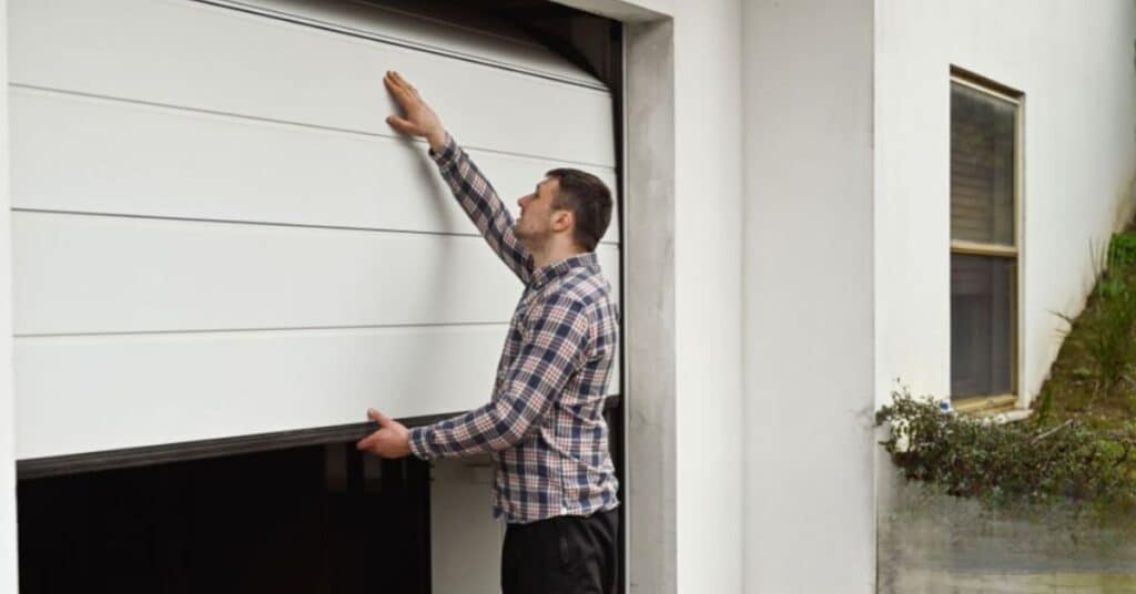 a person manually opening garage door from outside