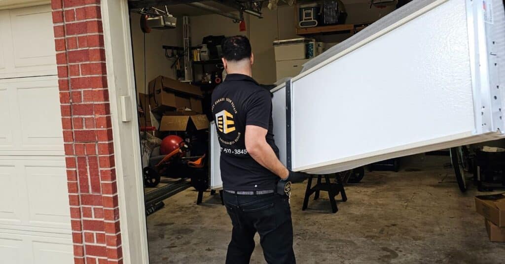 technician installing garage door panels