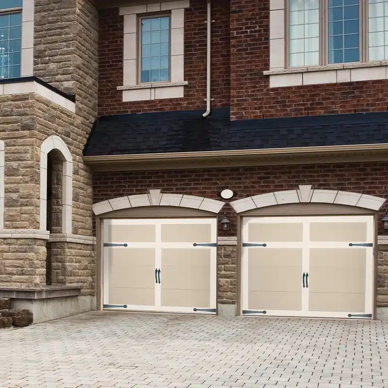 Carriage Creek composite-overlay carriage house garage door installed on a brick home